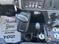 The image shows the interior controls of a 2008 International DuraStar including gear shifter buttons dashboard switches and a thank you notice on the floor