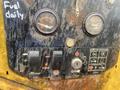 Control panel of a 2010 Vermeer Corporation BC1000XL with gauges for fuel and hours and various operation buttons