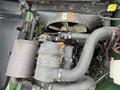 A 2009 John Deere 2653B Precision engine showing various components including the air filter battery and hoses