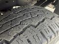 Close-up of a heavily treaded tire belonging to a 2011 Ford F-350 SD showing deep grooves and rugged texture