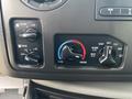 Interior controls of a 2013 Ford E-350 Super Duty showing climate settings including temperature adjustment and air flow options