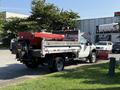 A white 2008 Ford F-450 SD pickup truck equipped with a silver dump bed and a red salt spreader attached to the back