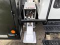 A close-up view of the hydraulic lift mechanism on a 2012 International DuraStar 4300 showcasing valves and controls