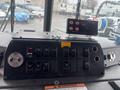 Control panel of a 2006 E-One Typhoon featuring multiple switches and a digital display for managing vehicle functions and equipment