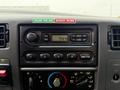Dashboard panel of a 2000 Ford F-450 featuring a radio with AM/FM options clock and controls for various settings