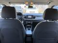Interior view of a 2018 Kia Rio5 showing the front dashboard steering wheel and two front seats with controls in the center console