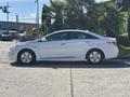 A silver 2015 Hyundai Sonata parked with a sleek profile showcasing its aerodynamic design and modern detailing