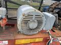 A weathered Baldor Air motor with a round casing and prominent ventilation grille showing rust and wear from age