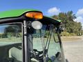A 2021 John Deere 1575 utility vehicle with a green roof, lights on top, and large front windshield