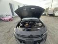 A 2015 Dodge Charger with its hood open revealing the engine compartment