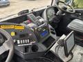 Interior view of a 2017 Autocar Xpert featuring a dashboard with controls a digital display and a large touchscreen monitor