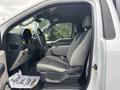 Interior view of a 2020 Ford F-150 showing the driver's side seat and dashboard with gray upholstery and a steering wheel