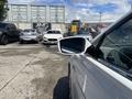 A 2014 Hyundai Sonata parked with its side mirror in focus showcasing its sleek design and white color
