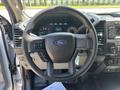 Steering wheel and dashboard of a 2019 Ford F-150 with digital displays and control buttons