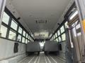 Interior view of a 2007 Freightliner B2 school bus showcasing empty rows of seats and an aisle leading toward the front of the bus