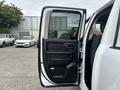 A 2016 RAM 1500 with the driver's door open, revealing the interior and door panel features
