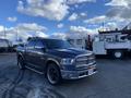 A 2017 RAM 1500 with a dark exterior and chrome accents parked with visible wheels and headlights