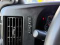 Dashboard controls of a 2020 Chevrolet Express including buttons for lights HVAC settings and a checkmark indicator
