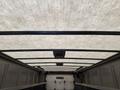 Interior view of a 2012 Ford Econoline cargo van showing the ceiling with a textured surface and overhead lights