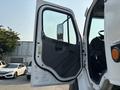 A 2016 Freightliner M2 106 truck with its driver's side door open displaying the interior controls and seat
