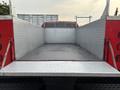 A 2015 Chevrolet Silverado 3500HD with a flatbed featuring a diamond plate surface and chrome accents