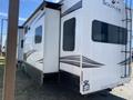 A 2021 Grand Design Recreational vehicle model ST3478MBS with a slide-out section visible on one side