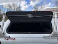 A 2018 Chevrolet Colorado with an open truck bed cover exposing the interior of the bed and a ladder rack installed on top