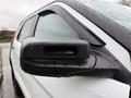 Close-up of a side mirror on a 2019 Ford Explorer with raindrops on the surface