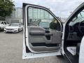 2018 Ford F-150 with an open driver-side door revealing the interior features including the dashboard and control panel