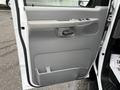 The image shows the interior side of a door from a 2006 Ford Econoline featuring a gray panel with a handle and control buttons