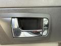 Close-up of a door handle with a chrome finish and buttons for locking and unlocking on a 2008 Kenworth T370