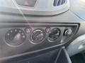 Dashboard controls of a 2017 Ford Transit featuring dials for air conditioning and heating along with a 12V power outlet