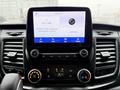 2020 Ford Transit dashboard featuring a touchscreen display with radio information and climate controls