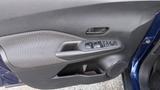 Close-up of the interior door panel of a 2019 Nissan Kicks featuring controls for windows and locks along with a textured surface