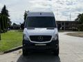 A white 2017 Mercedes-Benz Sprinter van with a high roof and a black lower front section viewed head-on