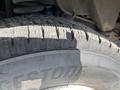 Close-up of a worn tire from a 2012 Ford Econoline with the tread pattern and brand name visible