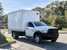 A 2016 RAM 5500 box truck with a white cargo area and black front grille parked on the street