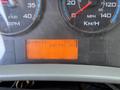 A close-up of the dashboard of a 2011 International 4300 displaying the RPM gauge the speedometer and an orange screen showing ENG PTO HRS and a reading of 332.7