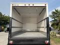 A 2008 Ford Econoline cargo van with an open rear door showing a spacious empty interior designed for transporting goods