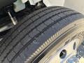 Close-up of a tire from a 2008 International DuraStar showing detailed tread patterns and a shiny alloy rim
