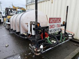 2000 Unknown 1250 Gallon Hook-Lift De-Icer featuring a large cylindrical tank with various hoses and fittings attached to a frame with a caution sign mounted on it