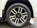 A close-up view of a 2018 Toyota 4Runner wheel featuring a black and silver alloy rim with a Yokohama Geolandar HT tire