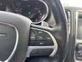 Close-up of the steering wheel controls of a 2015 Dodge Durango featuring buttons for cruise control and settings