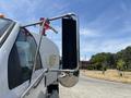 A 2015 Ford F-750 truck with a mounted side mirror featuring a rectangular black panel and chrome accents
