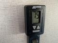 A digital thermostat displaying a temperature of 75 and an off button