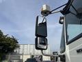 A 2013 International WorkStar truck with two side mirrors one larger and one smaller mounted on the driver's side