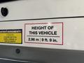 A height warning label on a 2021 Ford Transit-350 stating the vehicle's height as 2.96 meters or 9 feet 9 inches