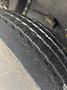 Close-up of a tire from a 2006 E-One Typhoon showing detailed tread pattern and surface texture with slight moisture visible
