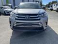 A silver 2018 Toyota Highlander with a prominent front grille and distinctive headlights facing directly towards the viewer