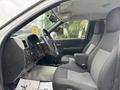 Interior view of a 2011 Chevrolet Colorado showcasing two front seats and the steering wheel with controls visible